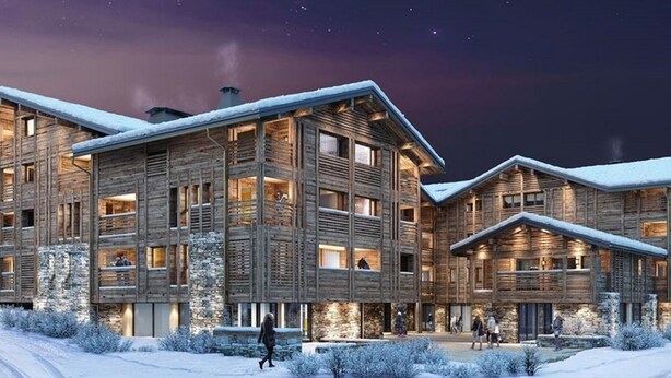 A modern log cabin hotel with multiple levels, large windows, and a snow-covered landscape.