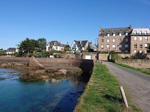 Stroll along the riverside path, taking in the serene views of the calm water and traditional and modern architecture.