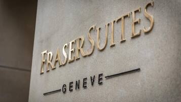 A sign with the words "FRASER SUITES" and "GENEVE" indicating the name of a hotel or property.