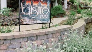 A building with a sign for 'Olde Bistrot Inn' and a covered porch area. - Top location, no cleaning fee, everthings close G (Lake Geneva)