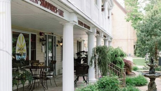A building with a sign reading "BEER-SMOKES-TAKE" and a patio area with tables and chairs. - Top location, no cleaning fee, everthings close G (Lake Geneva)