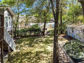 A residential area with a small house, a fenced yard, and a tree. - 5 Blocks 2 Beach-Pet Friendly- Golf Cart-Early Check-in (North Myrtle Beach)