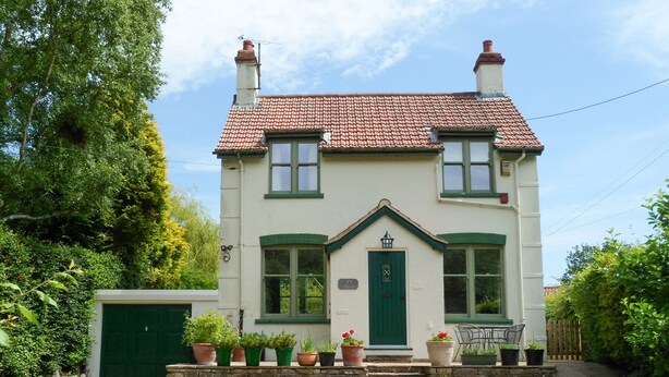 A two-story house with a green door, multiple windows, and a tiled roof. - Applegarth (Scarborough)