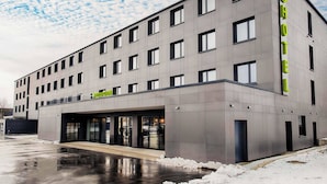 A modern hotel with a reception area and multiple windows.