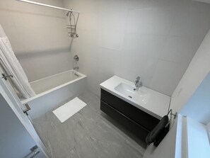 Bathtub, hair dryer, towels, soap