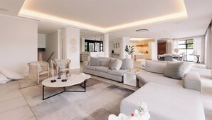A modern living room with a sofa, armchairs, and a coffee table. There is a kitchen area visible in the background. - MINT Resorts the Blyde (Pretoria)