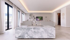 A modern kitchen with a marble island, large windows, and a flat-screen TV on the wall. - MINT Resorts the Blyde (Pretoria)