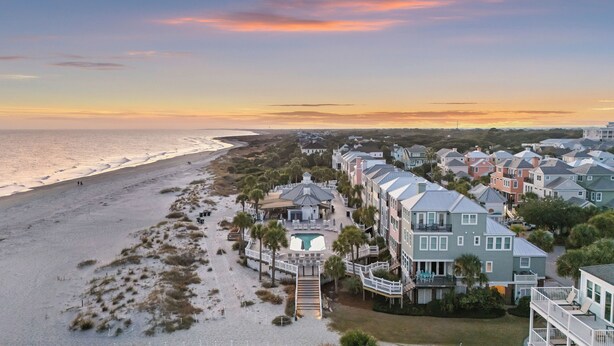 A coastal residential area with beachfront properties, a swimming pool, and a boardwalk leading to the beach. - Modern Grand Pavillon Home: Steps to Beach, Pool Access (Isle Of Palms)