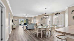 A spacious kitchen with a dining area, wooden flooring, and a view to the outside. - Three Bedroom Resort Condo close to Golf, Beach, Shopping & Popular Attractions (Myrtle Beach)
