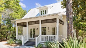 A white building with a covered porch, a number 16 sign, and a gravel driveway. - Charming home perfectly located near Seaside, Watercolor, and the best of 30A (Seagrove Beach)
