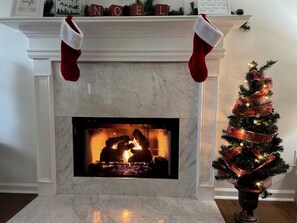A fireplace with stockings and a Christmas tree. - Xmas Avail! Billiards, Foosball & Ping Pong (Eatonton)