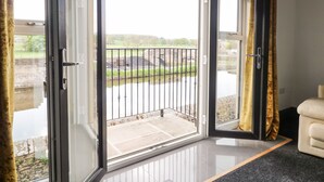 A room with a sliding glass door leading to a balcony with a metal railing. - 6 Lock View (Skipton)