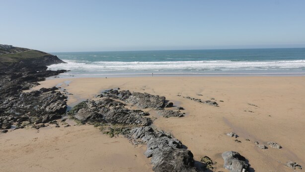 A coastal beach with rocky outcrops and a clear view of the ocean. - Estuary View (Newquay)