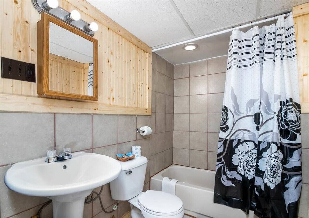 A bathroom with a sink, toilet, and bathtub.