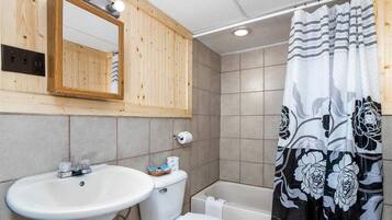 A bathroom with a sink, toilet, and bathtub.