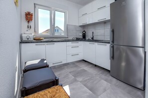 Apartment (A4) | Private kitchen | Fridge, stovetop, electric kettle, cookware/dishes/utensils