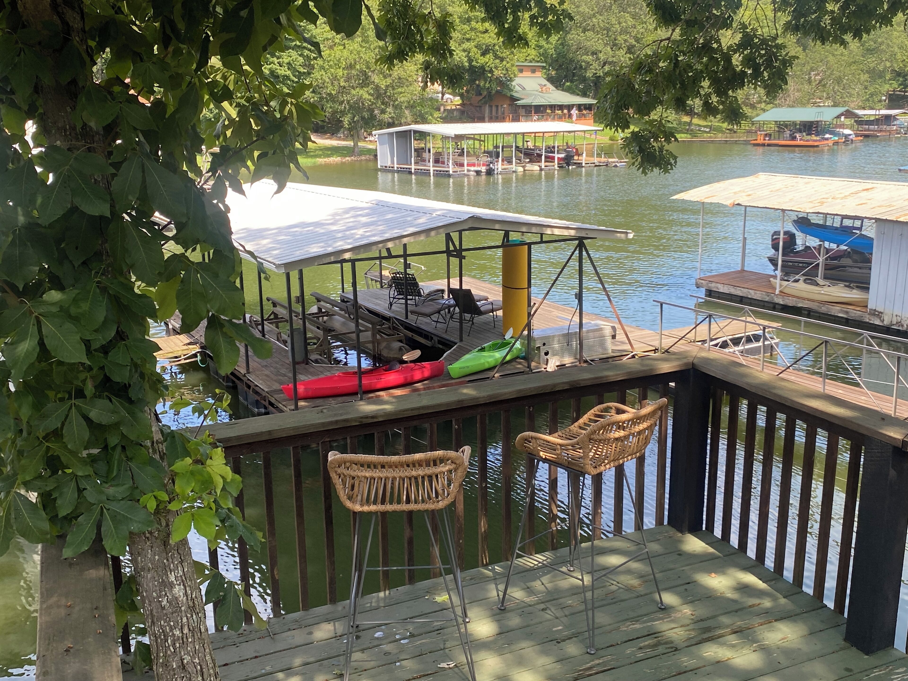 View of deck overlooking guest dock and lake.