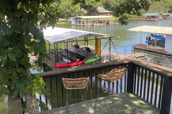 View of deck overlooking guest dock and lake.