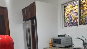 A kitchen with a stainless steel refrigerator, a microwave, and a sink. - Gorgeous House in the Center of Santiago (Santiago De Los Caballeros)