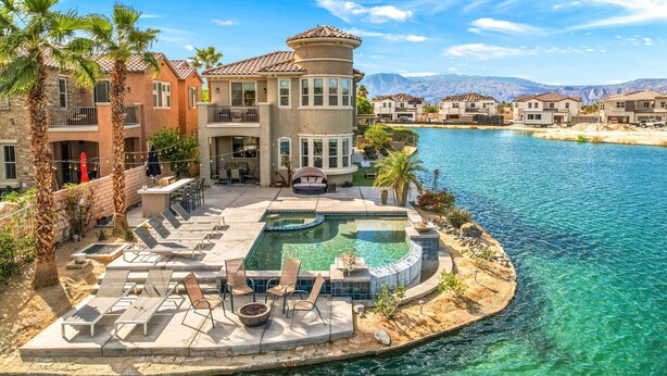 A luxurious resort with a large pool, outdoor seating, and a scenic mountain backdrop. - Lakefront Dream: Misters and The Best Corner Lot on the Lake! EV! (Indio)