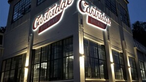 A building with illuminated signage reading 'Cartridge Brewing.'