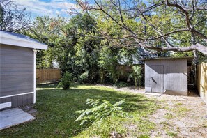Enjoy an and secure outdoor space surrounded by lush trees and a well-manicured lawn.