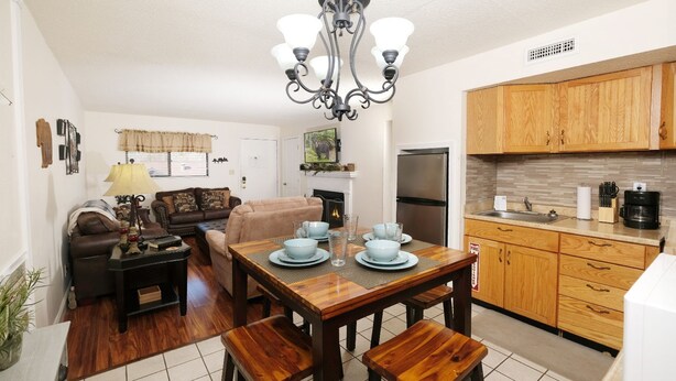 A compact living space with a dining area, kitchenette, and a living room. - Oak Square 305 - Ask About Free Attraction Tickets! (Gatlinburg)