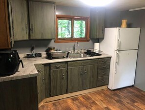 Fridge, microwave, coffee/tea maker, cookware/dishes/utensils