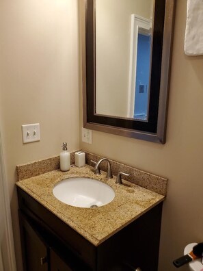 Combined shower/bathtub, towels, soap, toilet paper
