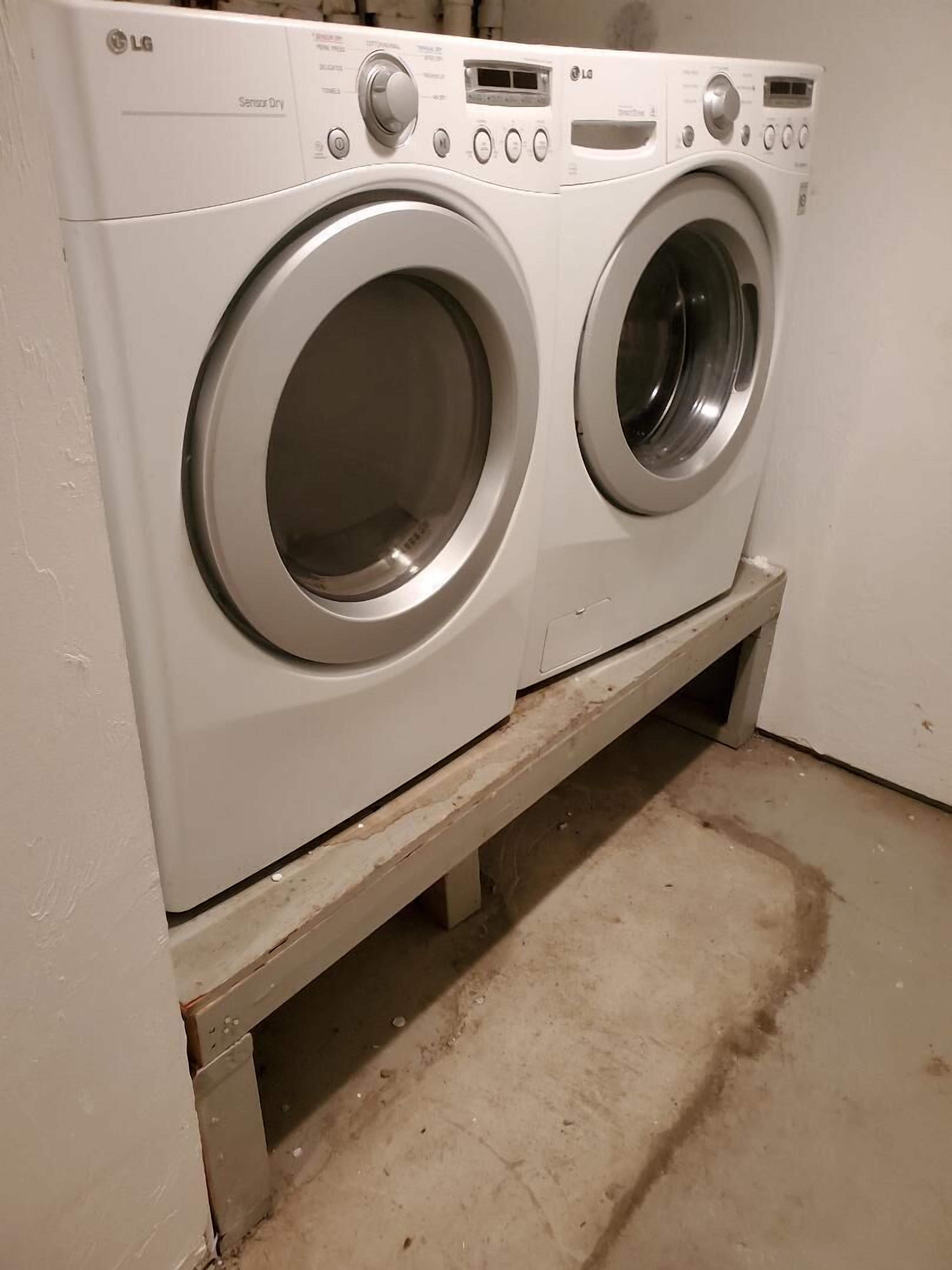 A front-loading LG washer and dryer unit with a control panel, installed on a concrete floor.