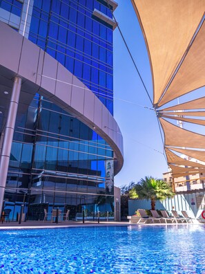 Outdoor pool, open 6:00 AM to 10:00 PM, pool umbrellas, sun loungers