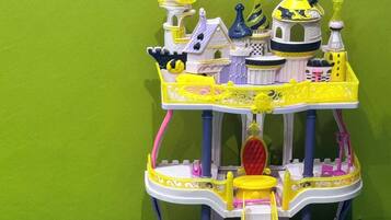 A multi-level toy castle with stairs, platforms, and various architectural details.