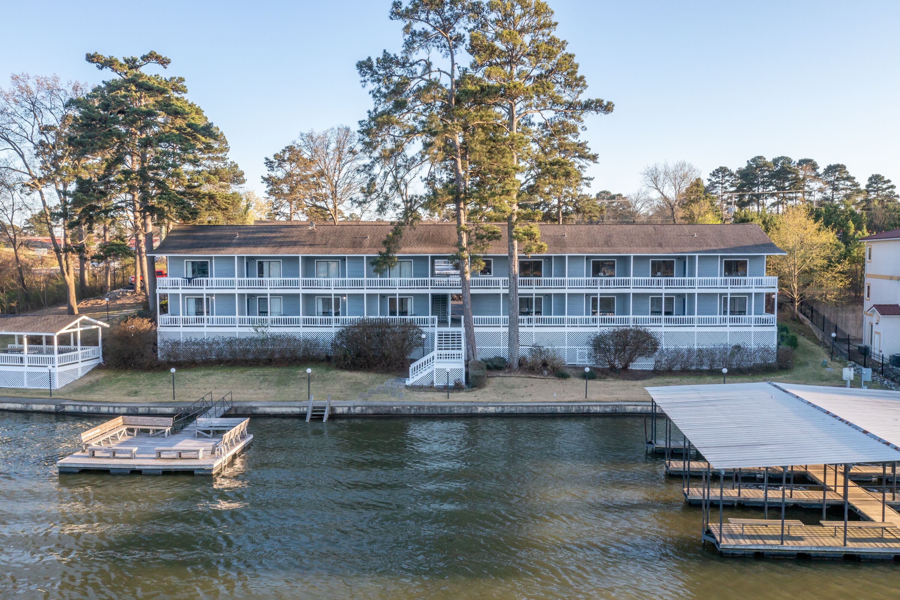 A two-story building with a dock and a covered area.