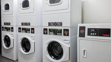 A row of commercial dryers in a laundry facility.