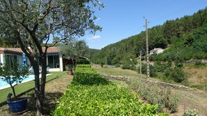 A residential property with a swimming pool, a well-maintained garden, and a view of a hillside. - Self-contained, air-conditioned studio, swimming pool just for you, rated 2*. (Ucel)
