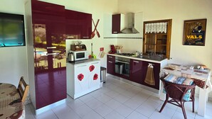 A modern kitchen with a wooden ceiling, white cabinets, and a dining area with a table and chairs. - Self-contained, air-conditioned studio, swimming pool just for you, rated 2*. (Ucel)