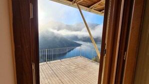 A balcony with a view of a mountain range and a body of water. - Amazing Lake View (Castel di Tora)