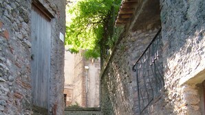A narrow stone staircase leading up to a building with a wooden door and a metal gate. - Amazing Lake View (Castel di Tora)