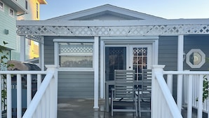 A residential house with a front porch, a garage, and a staircase leading to the entrance. - Waterfront Home in Gulf Harbors with Deepwater Access to Gulf with No Bridges (New Port Richey)