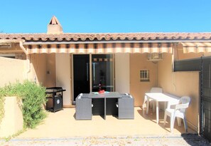 Relax outdoors with a patio featuring a table, chairs, grill, and a charming dining area.