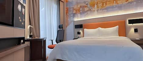 A modern hotel room with a large bed, a desk, a chair, a TV, and a wall with a cityscape mural.