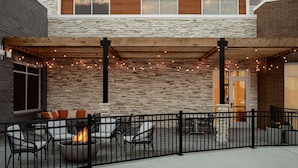 An outdoor patio area with a fire pit, seating, and string lights. - Hilton Garden Inn Mt.juliet (Mount Juliet)