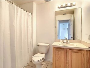 Combined shower/bathtub, towels, soap, toilet paper
