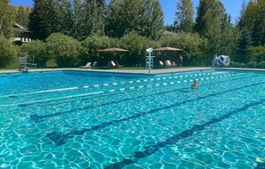 Relax by the pool surrounded by lush trees and enjoy a refreshing swim.