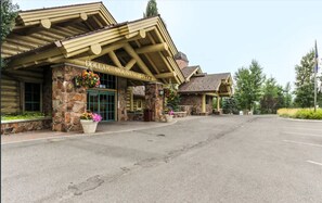 Situated in a scenic setting, the Dollar Mountain Lodge offers a charming entrance with a flower-adorned overhang.