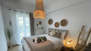 Un dormitorio con cama, mesita de noche, lámpara y decoración mural.