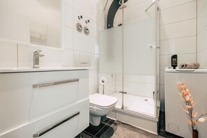 Shower, towels, soap, toilet paper