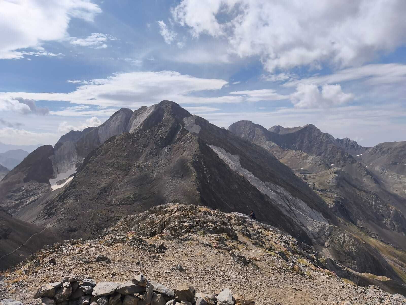 A rugged mountain landscape with rocky terrain and a clear sky.