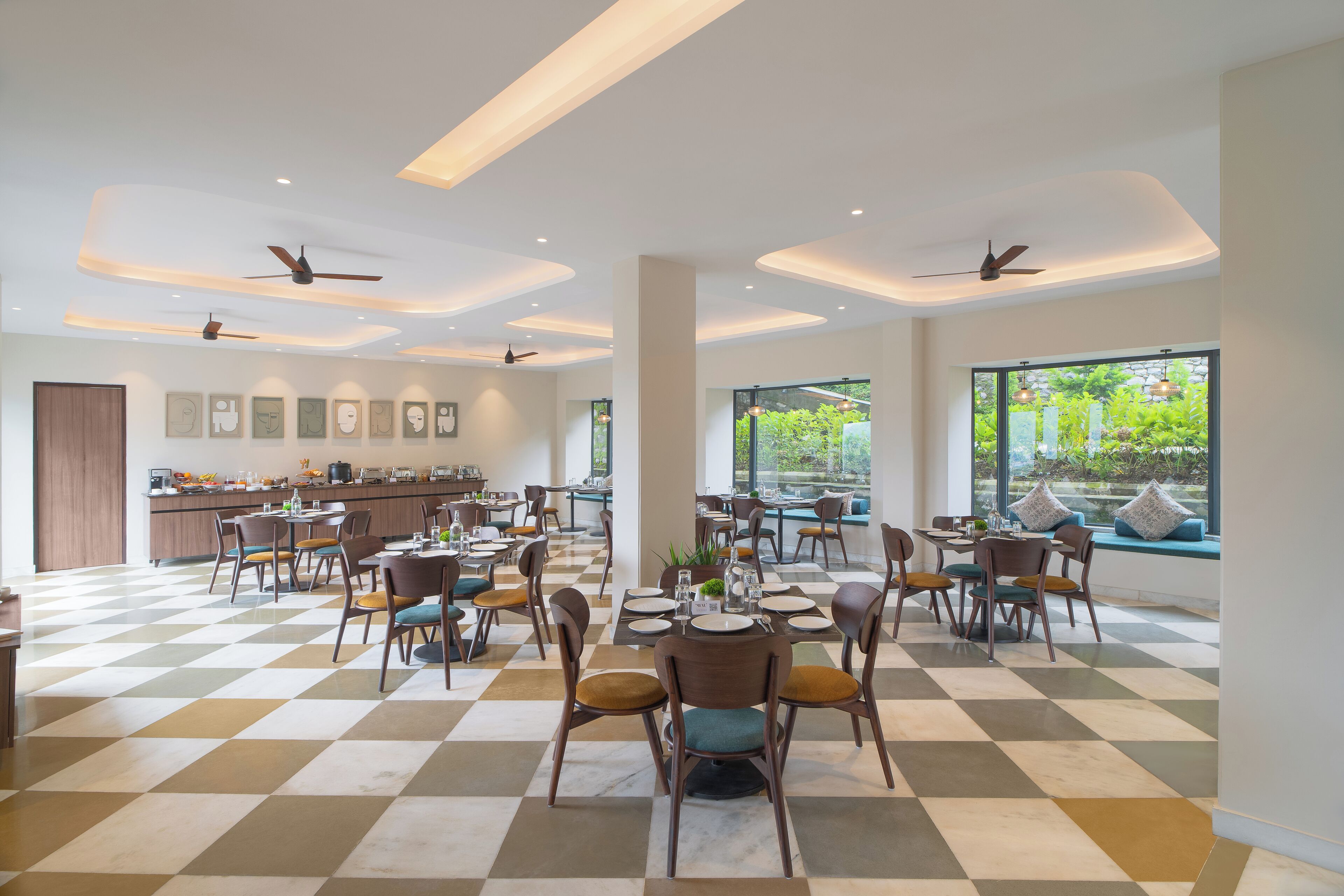 A spacious dining area with checkered flooring, multiple tables, and chairs.