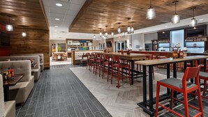 A modern restaurant interior with wooden ceiling, bar area, and seating arrangements. - Holiday Inn Clarksville Northeast by IHG (Clarksville)